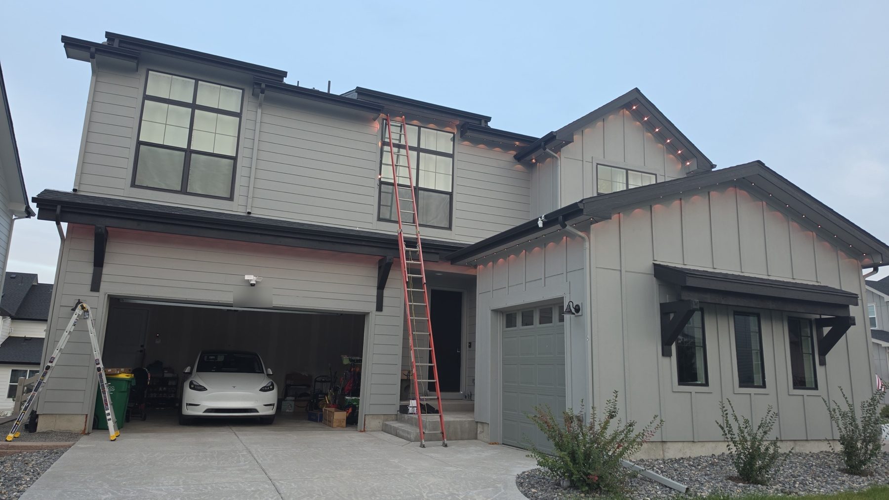 The same home in daylight: the lighting track is barely visible under the eaves
