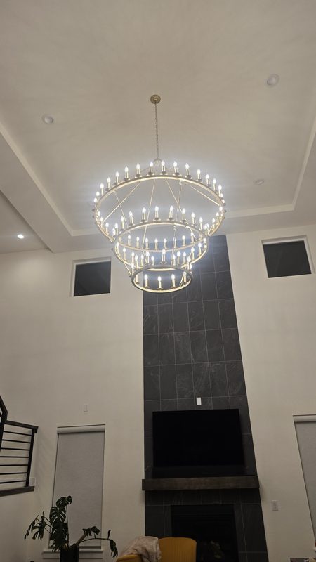 Three-tier chandelier hung in a two-story great room